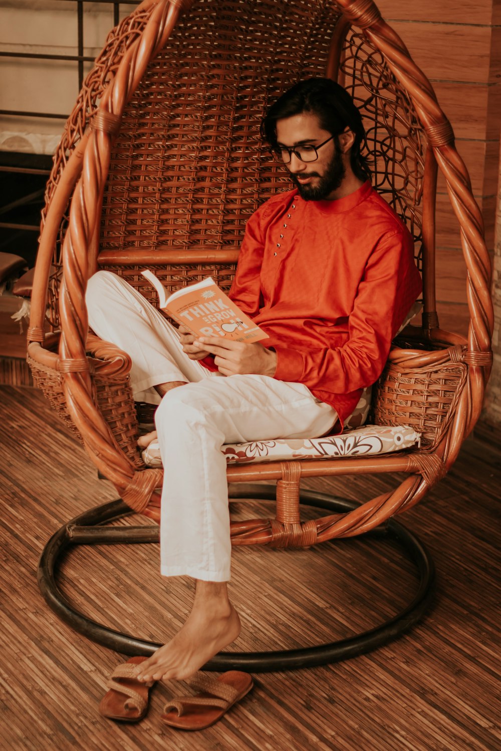 man in red long sleeve shirt reading book