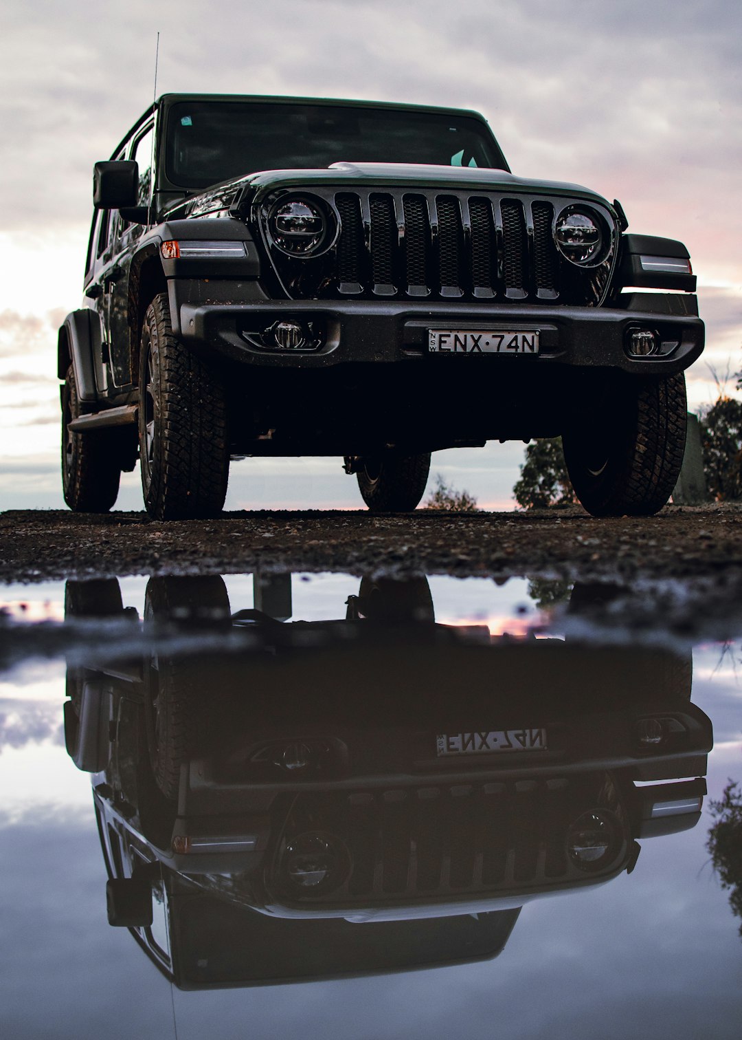 black jeep wrangler on dirt road during daytime