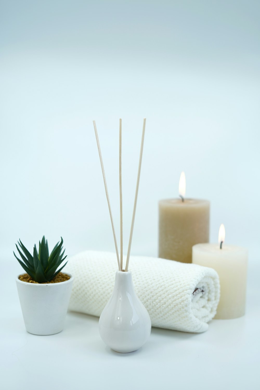 white pillar candles on white ceramic holder