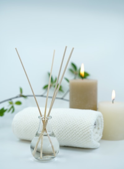 white pillar candle on silver holder