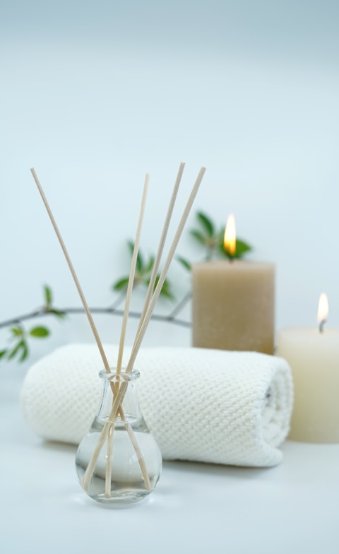 white pillar candle on silver holder