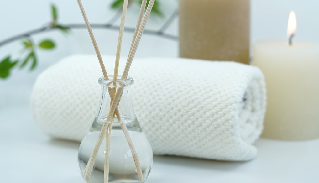 white pillar candle on silver holder