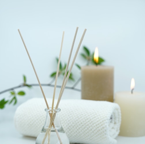 white pillar candle on silver holder