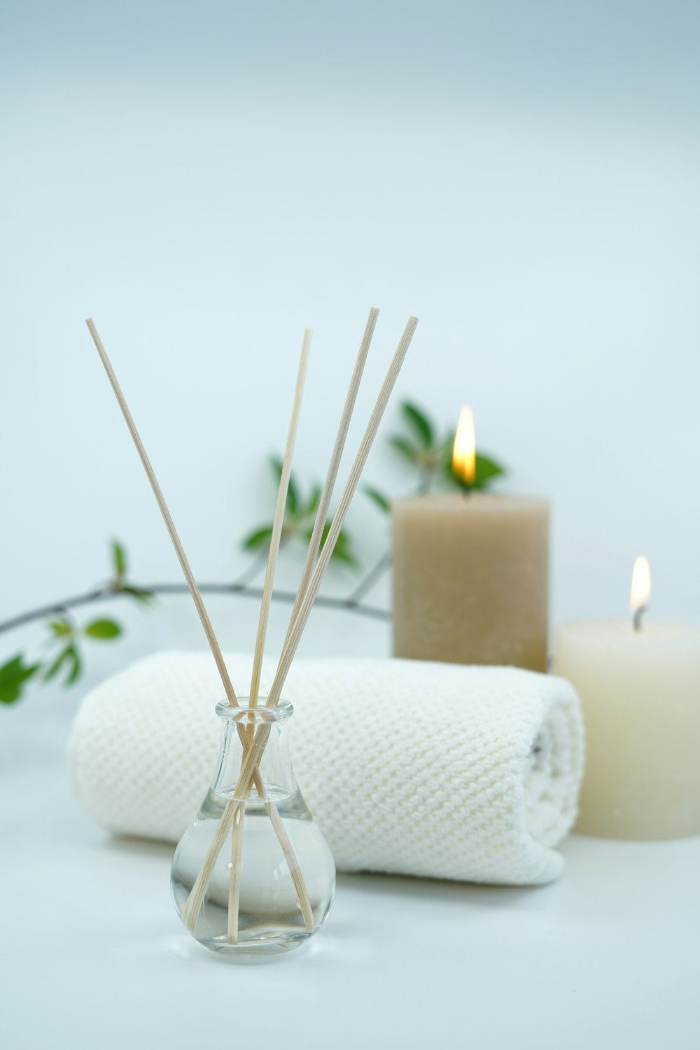 white pillar candle on silver holder