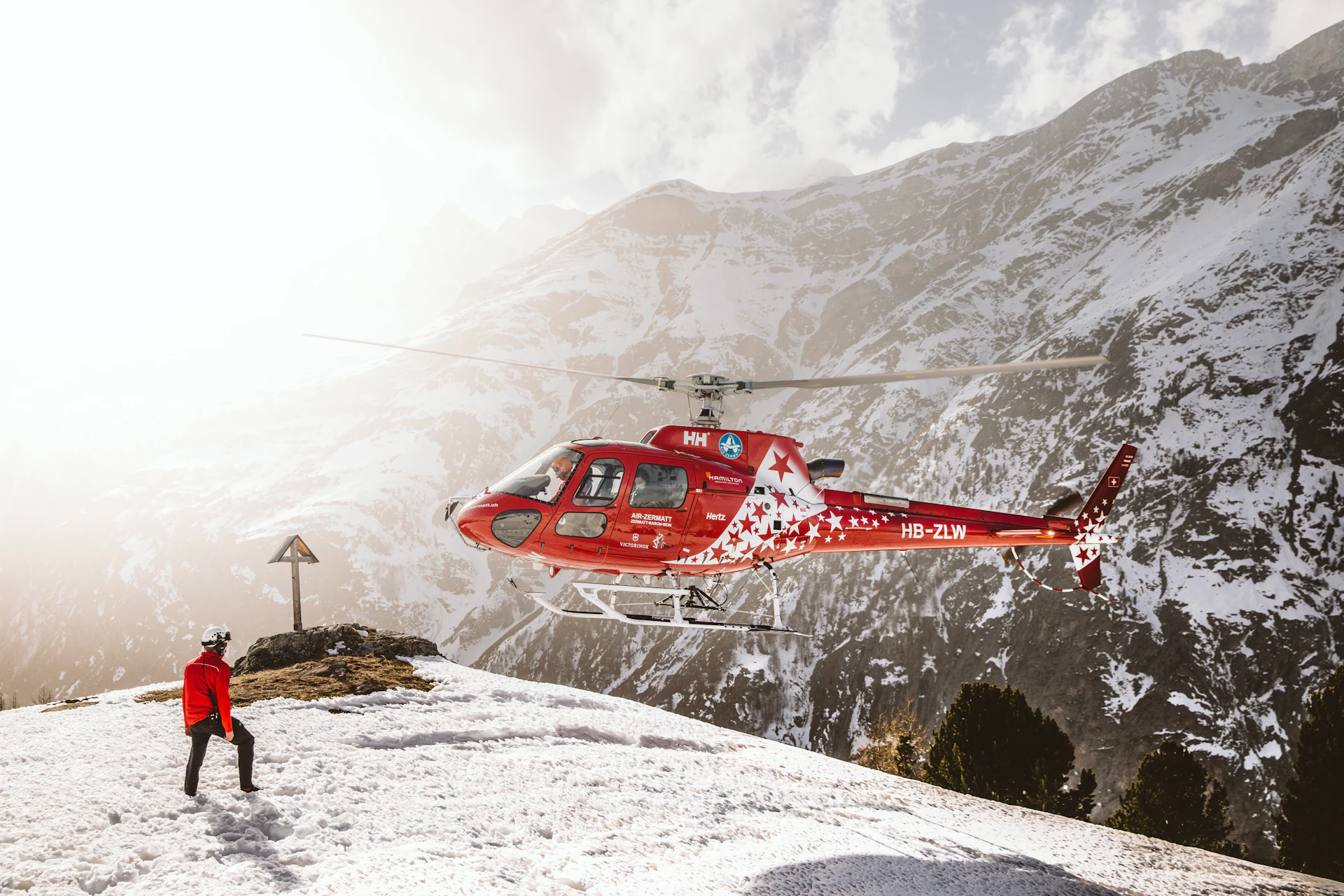 Helicopter flying over snow-covered mountains