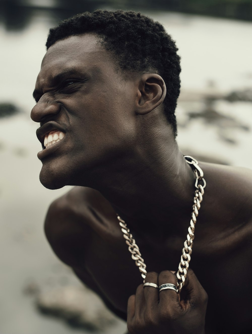 topless man with silver chain necklace