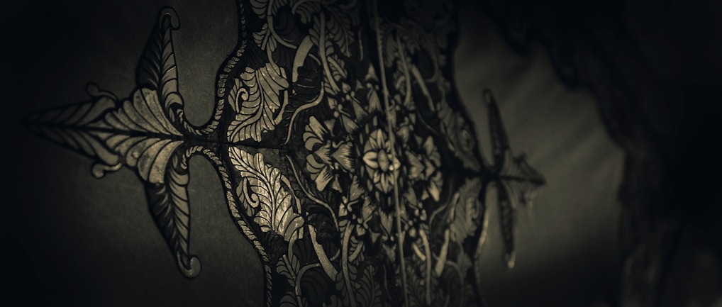 Intricate printmaking artwork showcasing fine details and textures on a white bordered dark background.