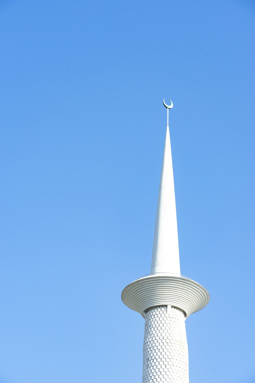 white concrete tower under blue sky during daytime