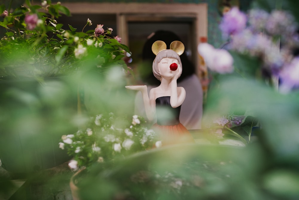 white and brown bear plush toy on green plant