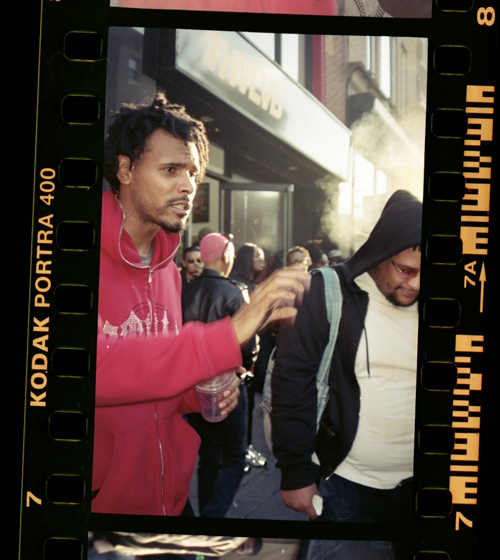 man in black jacket standing beside woman in pink jacket