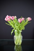 Delicate pink tulips arranged elegantly in a glass vase