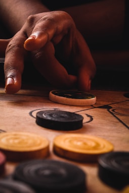 person holding silver and gold coins