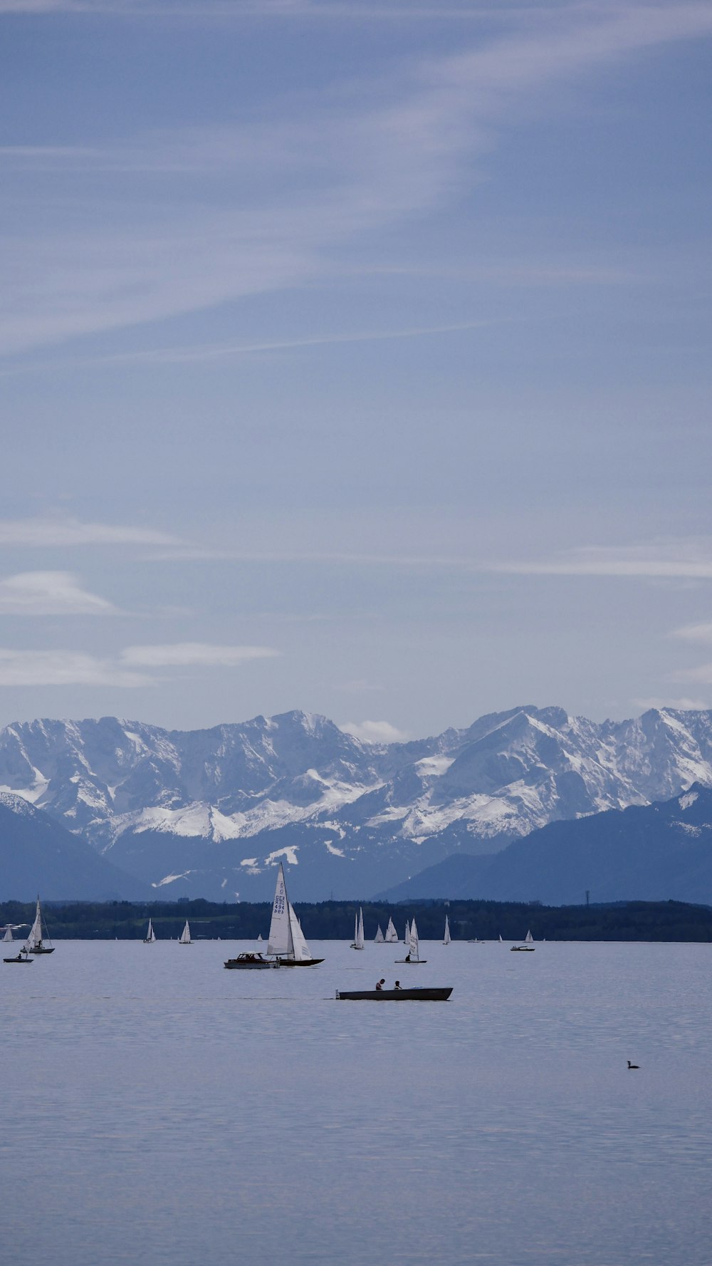 white airplane on the sky over the mountains