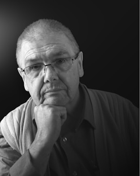 A professional portrait of Dr Pynda Raja Vardhaman in a thoughtful pose.