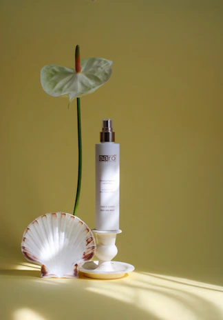 Close-up of elegant tropical accessories displayed on a minimalist white background.