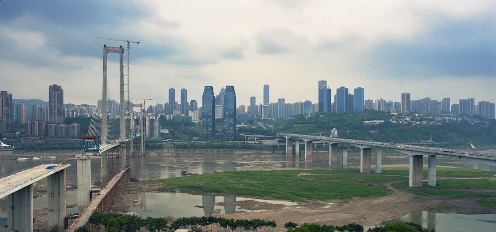 a bridge over a body of water with a city in the background