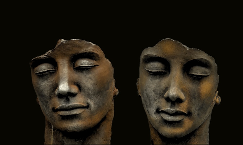 mans face carved on black surface