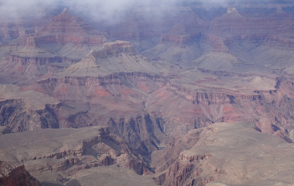 brown and gray mountains under white clouds during daytime