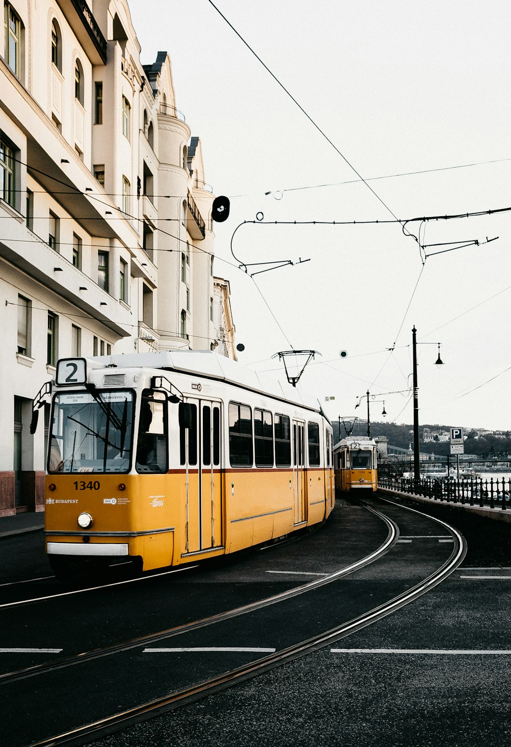 yellow and white tram on the street during daytime