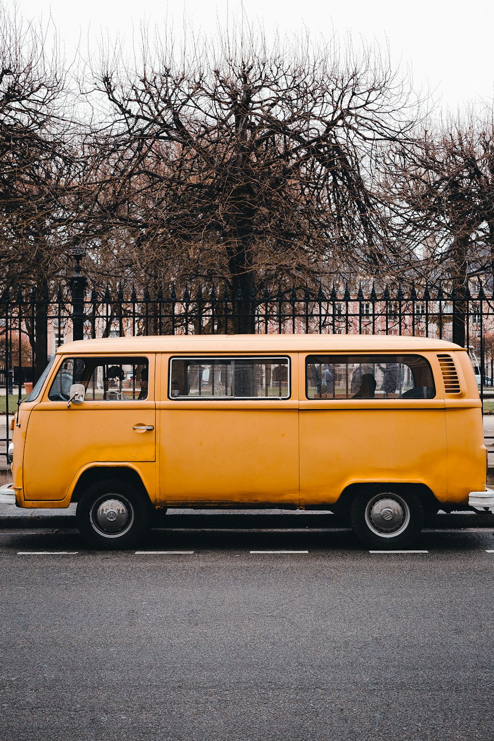 yellow volkswagen t-2 parked on sidewalk during daytime