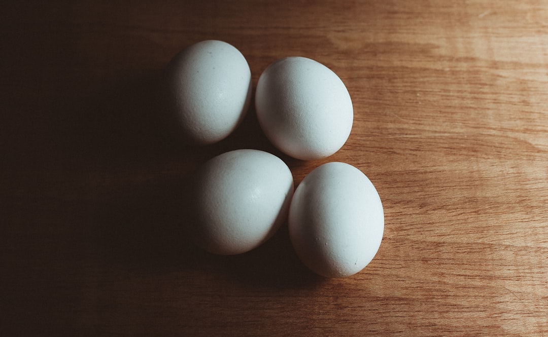 white eggs on brown wooden table