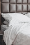 white bed pillow on bed