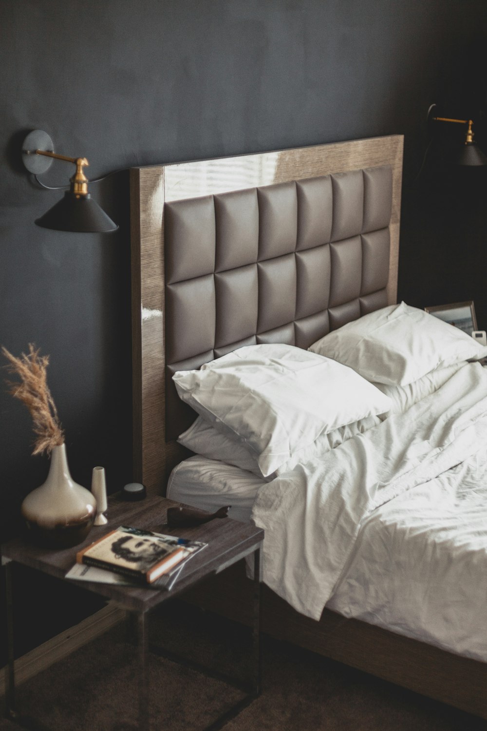 white bed linen near brown wooden nightstand