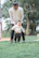 Therapist gently guiding a child through a playful physical therapy exercise.