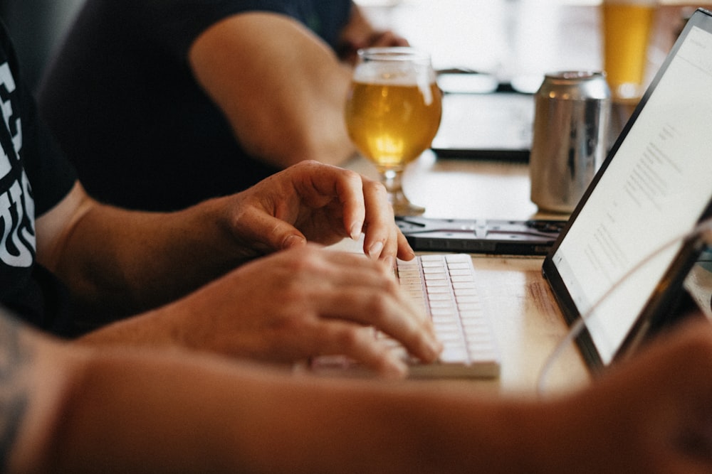 person using macbook pro on table