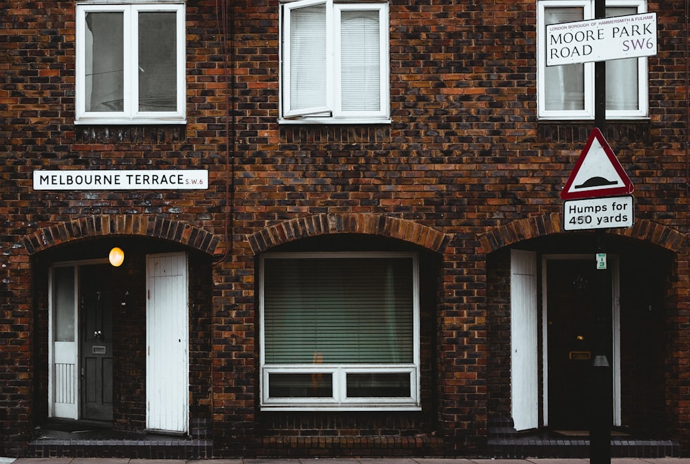 brown brick building with white wooden window