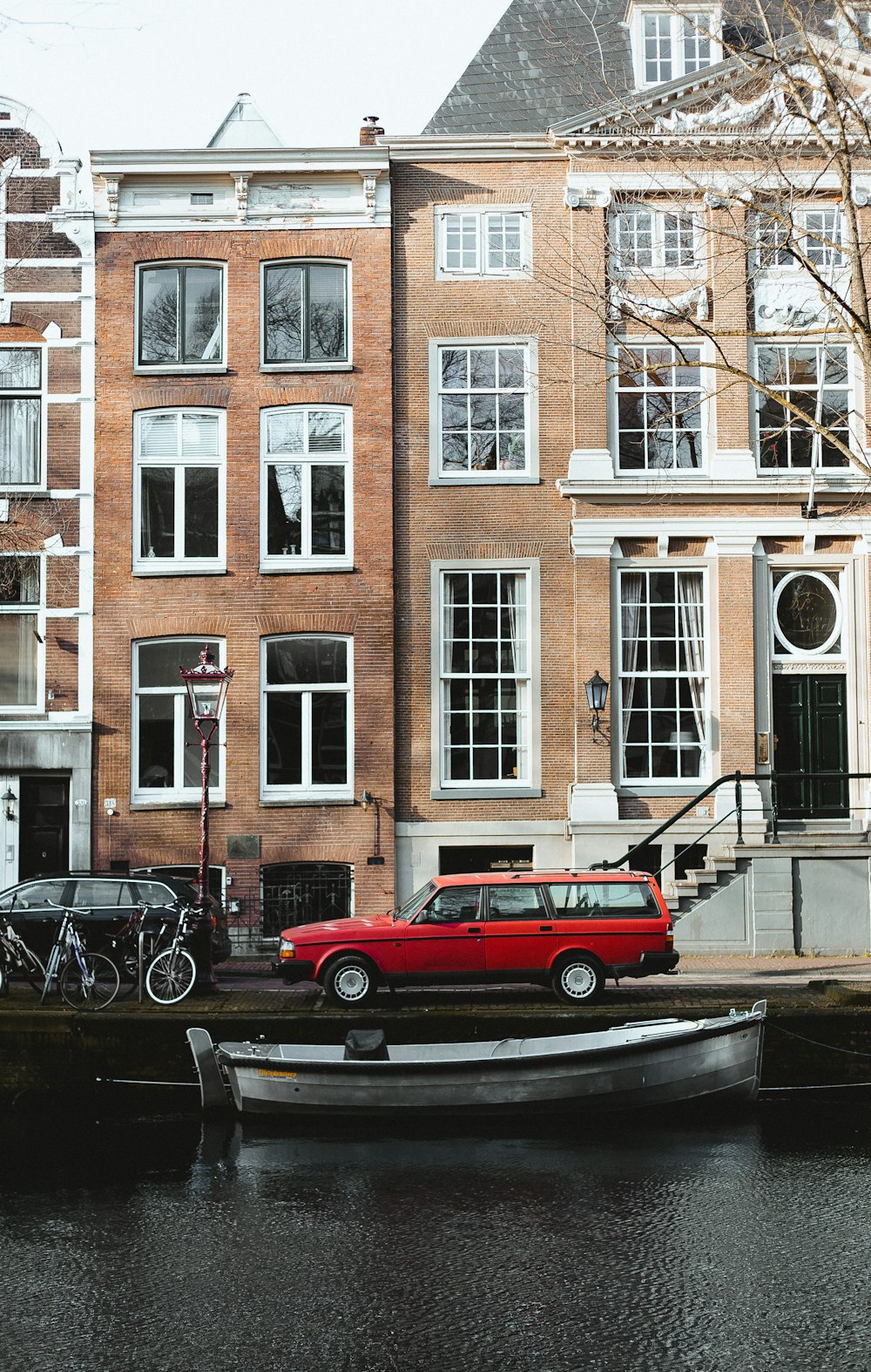 red car parked beside black car