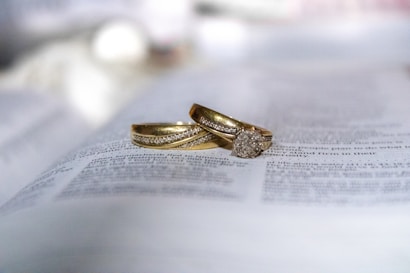 gold diamond ring on white printer paper