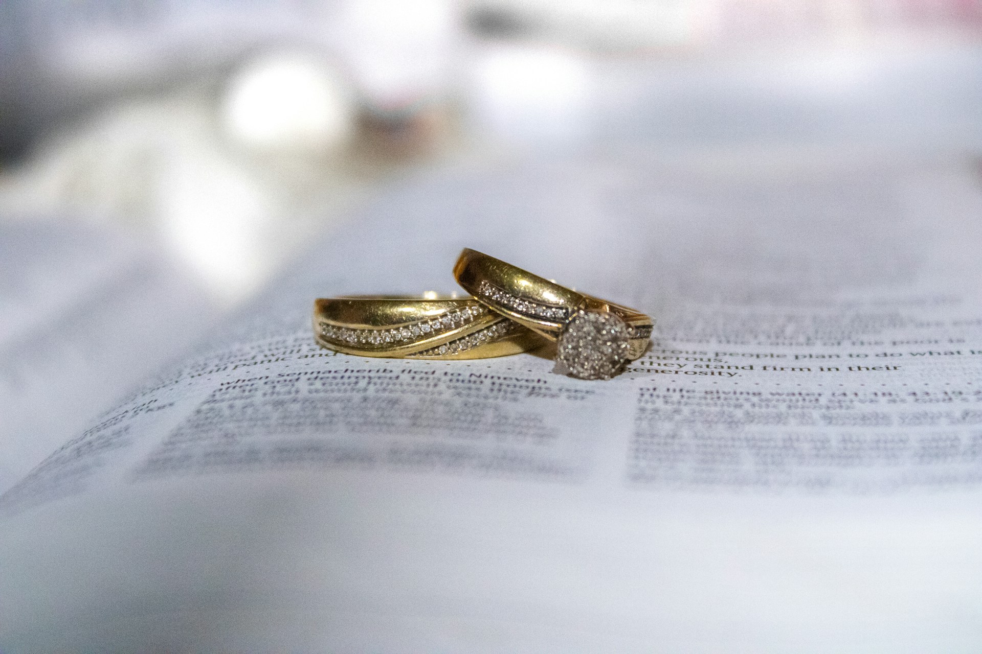 gold diamond ring on white printer paper