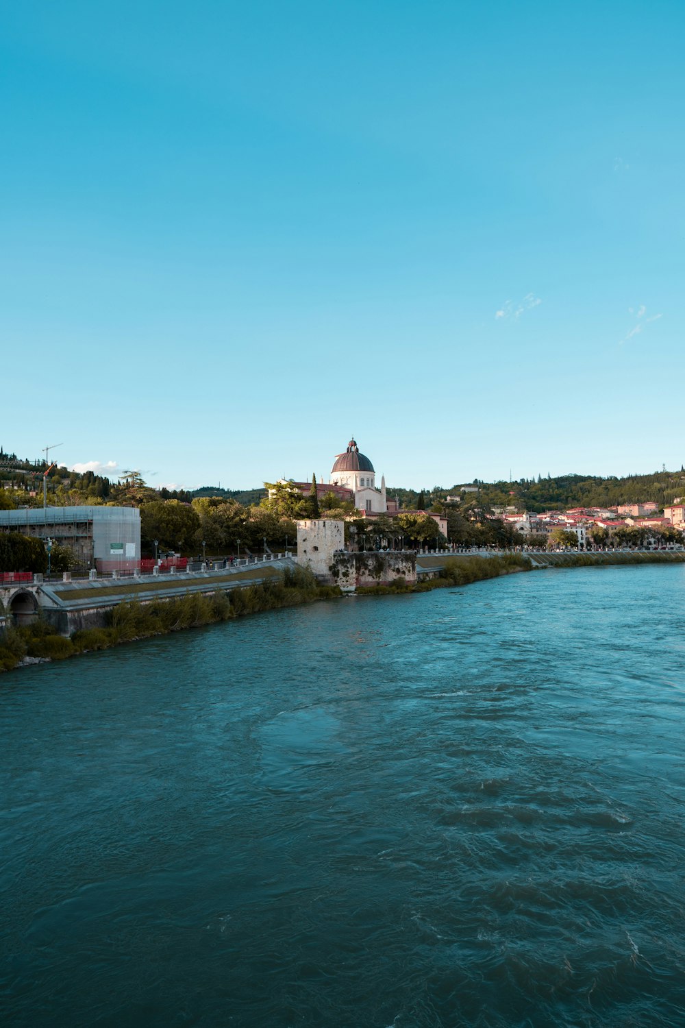 white and brown concrete building near body of water during daytime