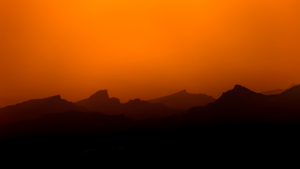 silhouette of mountains during sunset