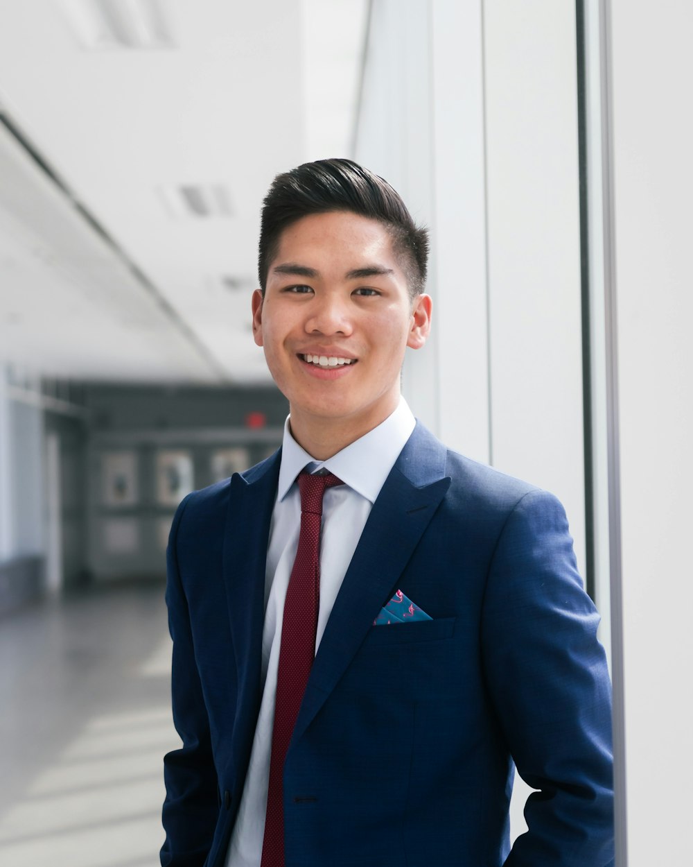 man in blue suit jacket smiling