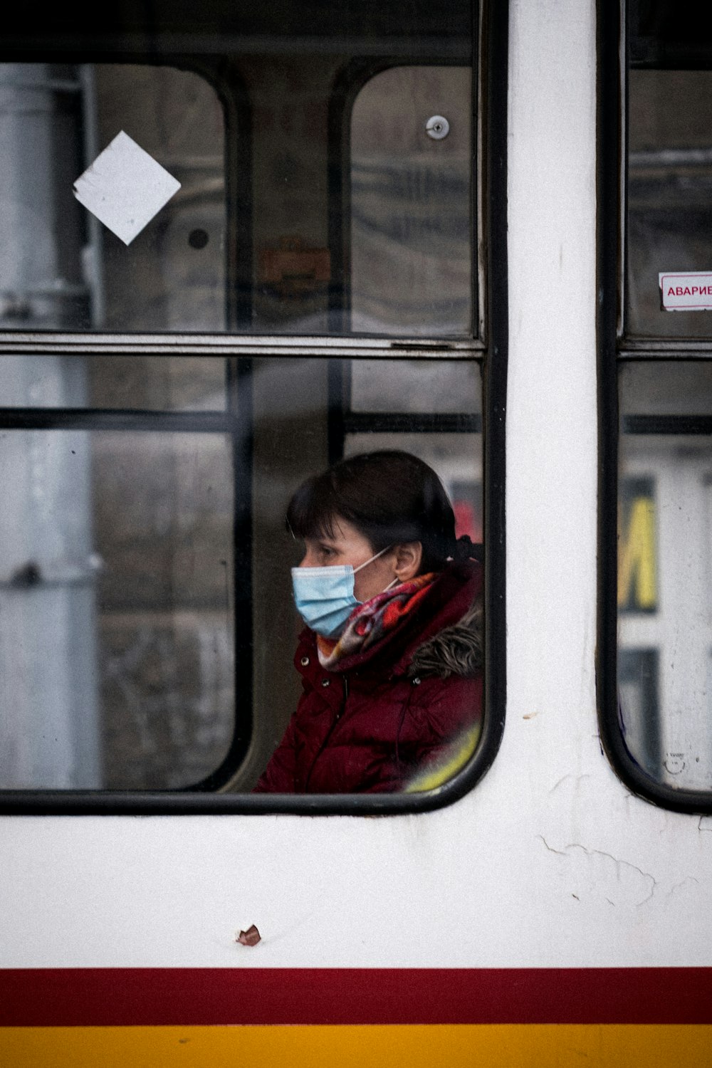 boy in red jacket sitting on train