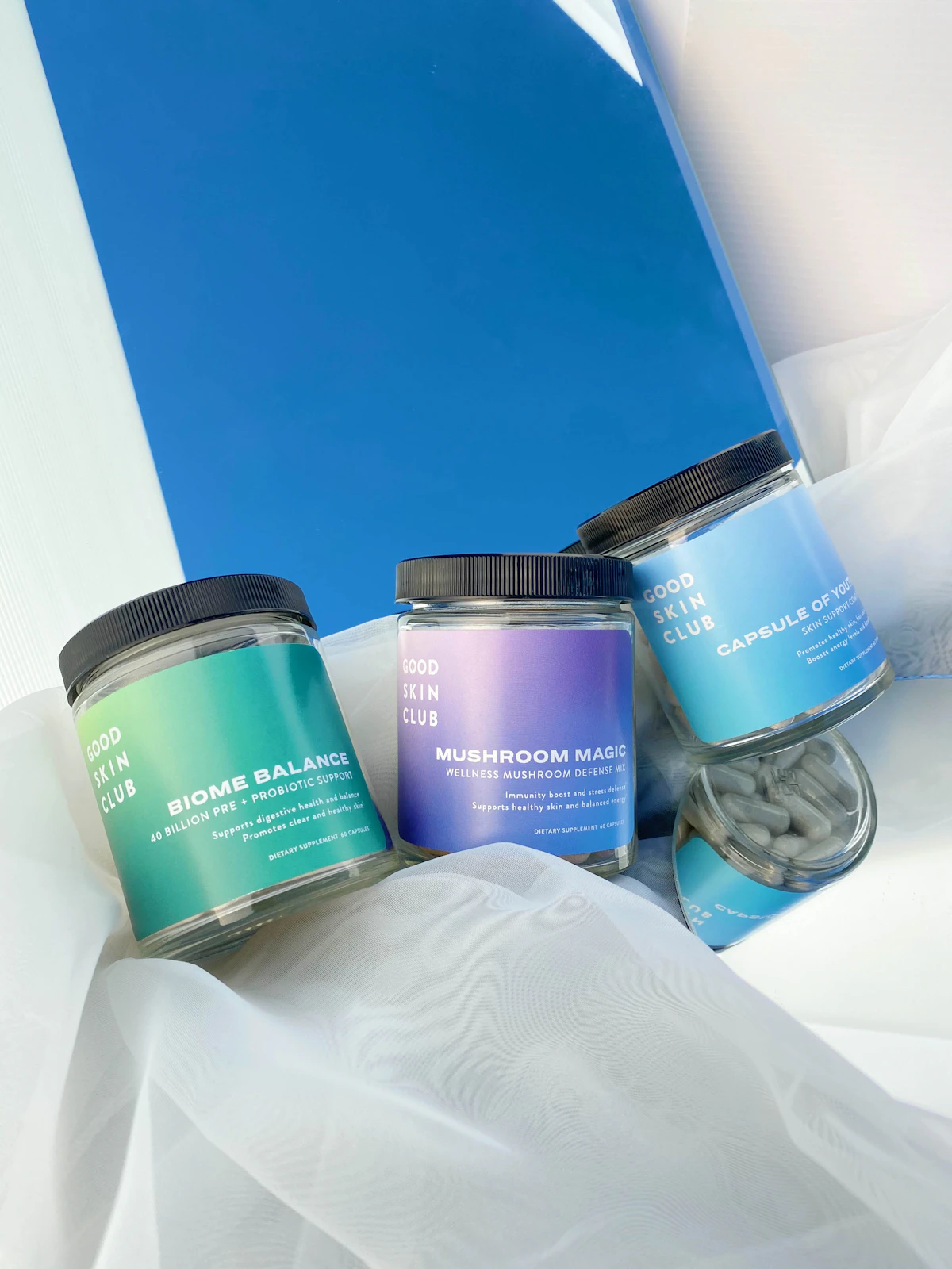 Wellness supplement jars with probiotics and mushroom capsules for gut-skin health