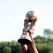 A happy young man holding the Copa 2026 glass cup with a black and gold background.