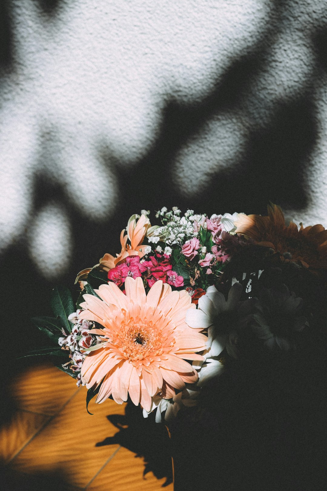 orange and pink flowers on black and white textile