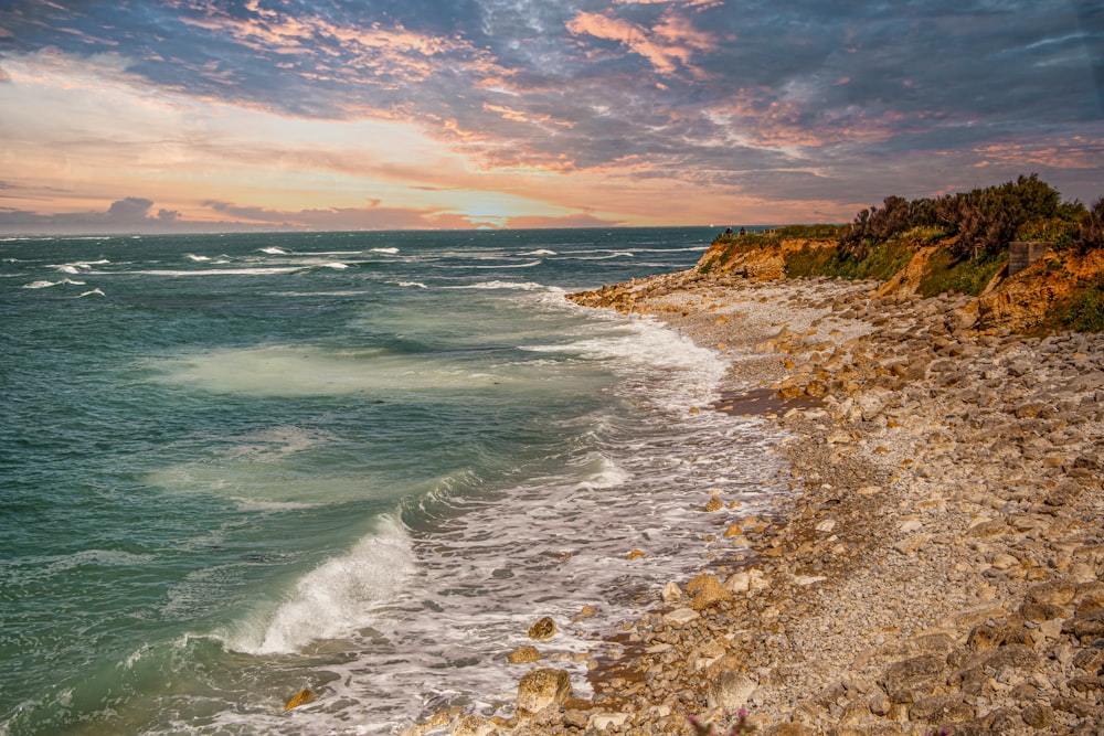 ocean waves crashing on shore during daytime