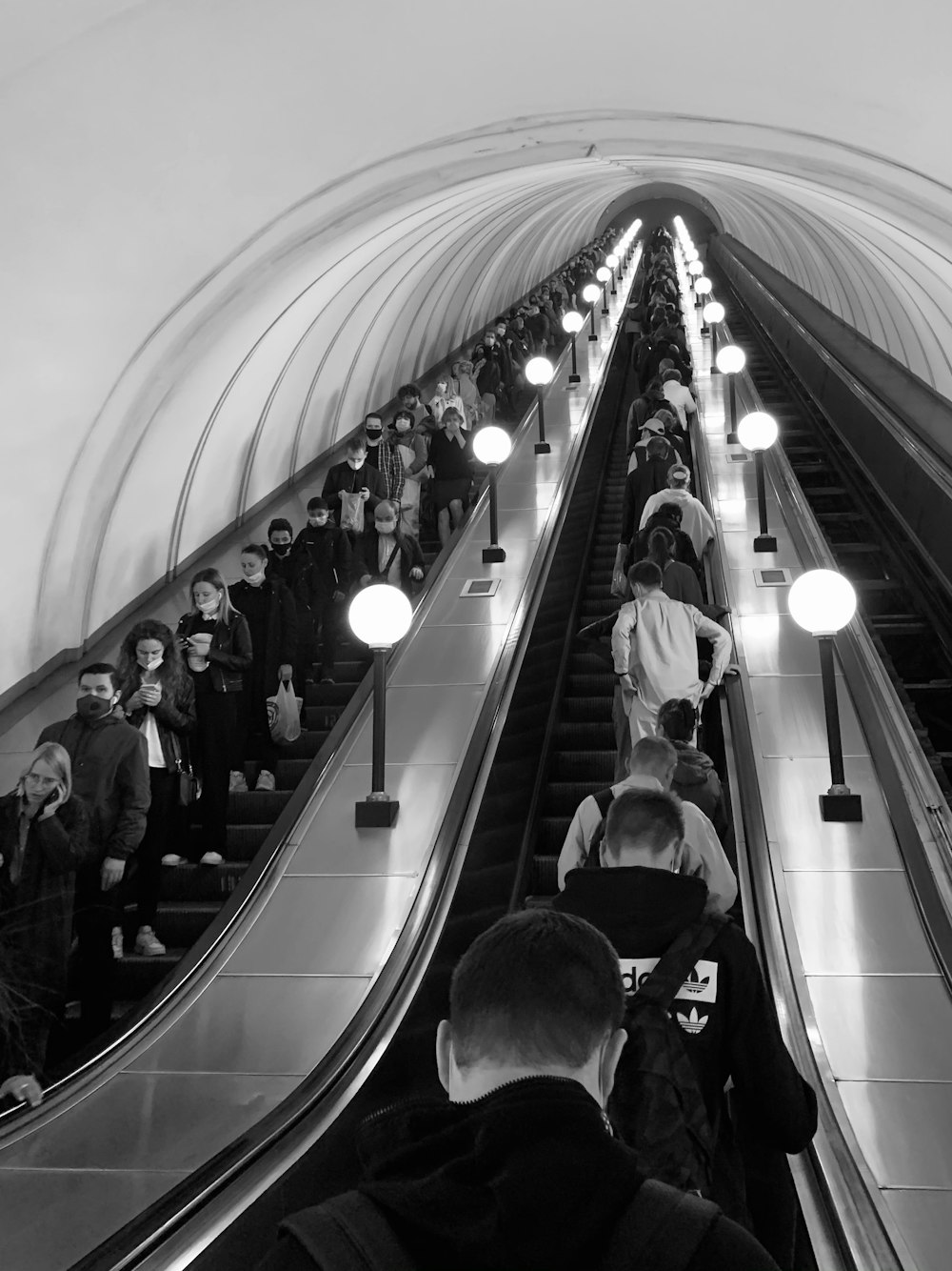 grayscale photo of people in a train station