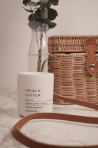 Elegant white candle with subtle floral aroma, placed on a classic French-style table setting.