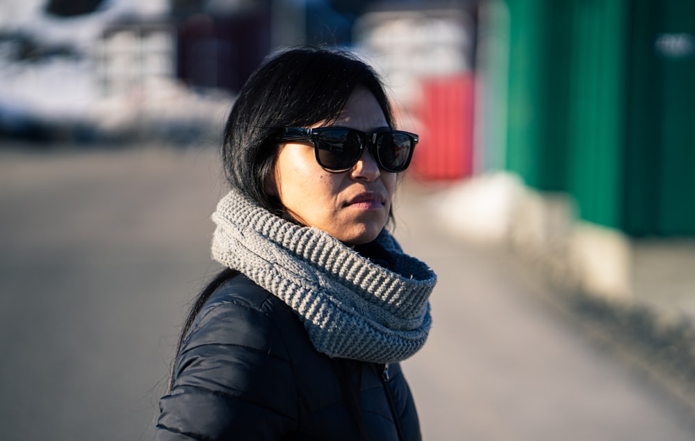 woman in black leather jacket wearing black sunglasses