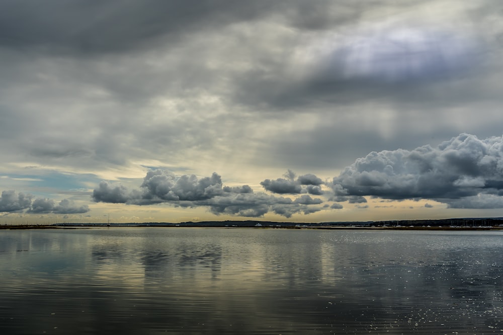 body of water under cloudy sky during daytime