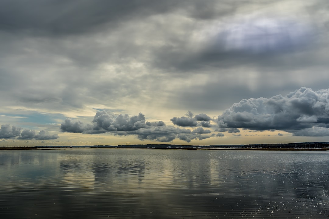 Low clouds over a still sea.