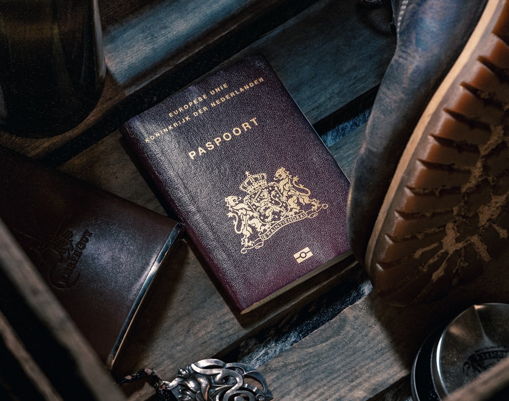 black leather bifold wallet on black leather textile