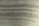 A close-up view of a printed German text, slightly blurred in the foreground and background, with a focus on the middle section. The document appears to be formal or academic in nature.