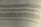 A close-up view of a printed German text, slightly blurred in the foreground and background, with a focus on the middle section. The document appears to be formal or academic in nature.