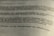 A close-up view of a printed German text, slightly blurred in the foreground and background, with a focus on the middle section. The document appears to be formal or academic in nature.